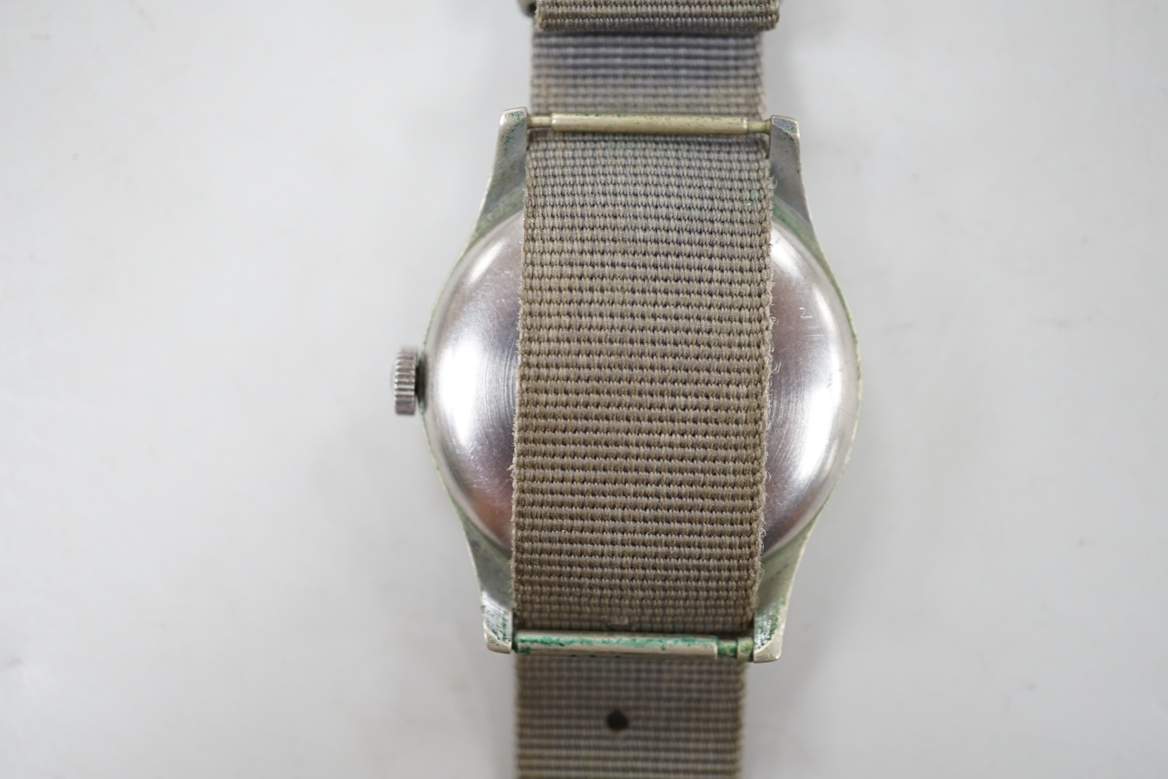 A gentleman's early 1940's stainless steel military issue Omega manual wind wrist watch, on fabric strap, the case back inscribed 'HS arrow 8 over 3282', movement c.30T2.